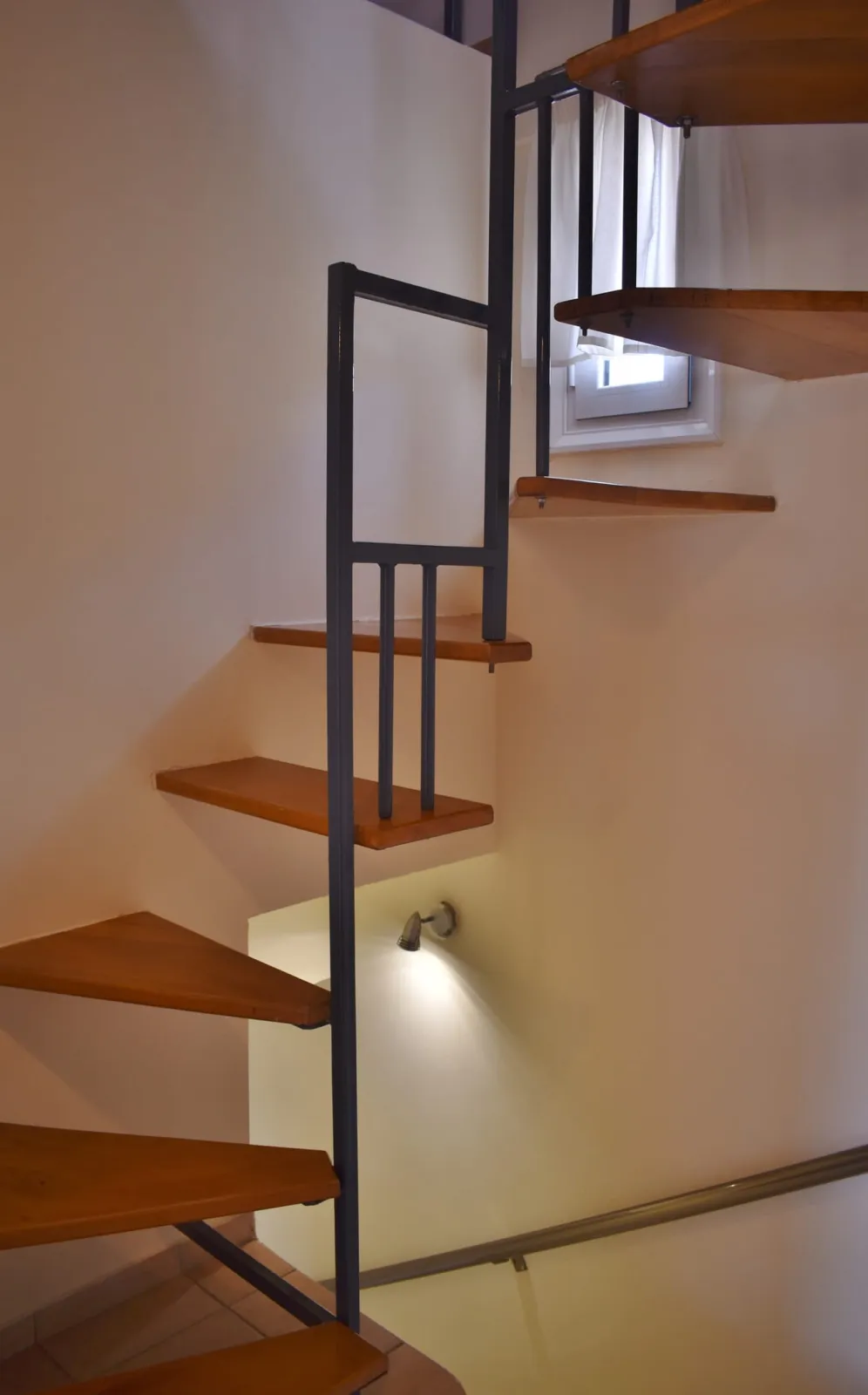 Stairs from the second level to the attic with the balcony overlooking the sea