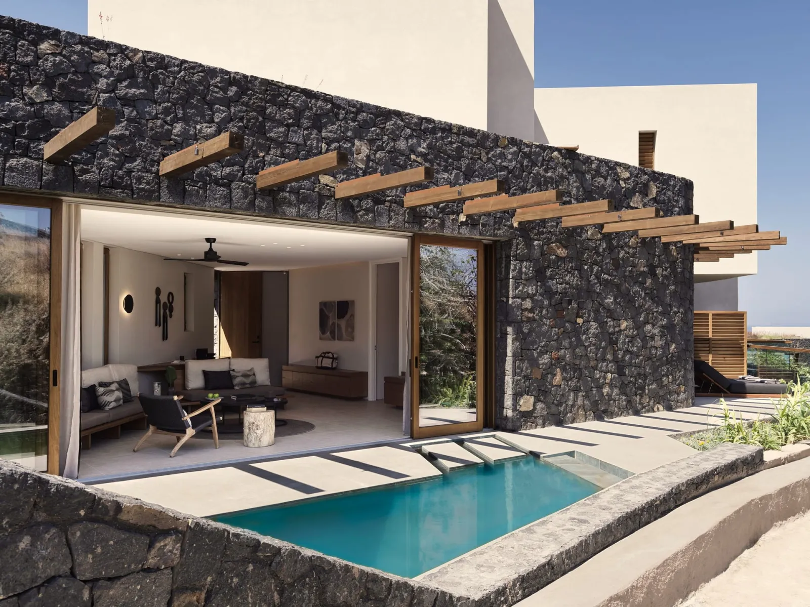 Indulge in the grandeur of 59 rooms and suites with breathtaking views of the Aegean Sea, complemented by private pools and Jacuzzis surrounded by green vineyards.