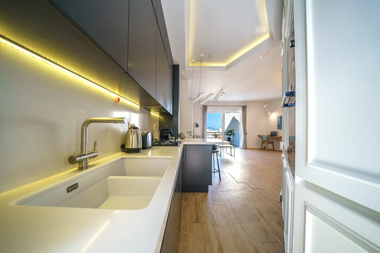 corridor that leads from the kitchen to living room area